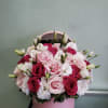Pink and white rose bouquet in a round pink box