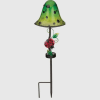 Green garden stake lamp with a ladybug decoration