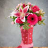 Pink roses and lilies arranged in a pink cowboy boot vase