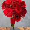 Red rose and gerbera daisy bouquet in a red wrap on a stand