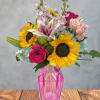 Mixed bouquet with sunflowers, lilies, roses, and hydrangeas in a pink vase