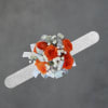 Bright clusters of bright orange roses make this wrist corsage a vivid