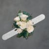 Silver wristband-worn white rose corsage perfect for prom, wedding, or any dressy