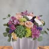 A soft blend of blush roses and lavender alstroemeria makes an immediate
