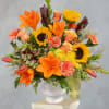 Bright orange lilies and sunny sunflowers create an immediate sense of warmth