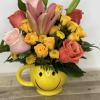 Bouquet of roses and lilies in a yellow smiley-face mug