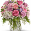 Pink and lavender rose bouquet in a clear glass vase