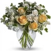 Bouquet of cream and white roses in a clear glass vase