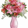 Pink roses and lilies in a pink glass vase