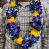 A bold, tropical floral lei that makes the recipient feel celebrated the