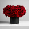 Red rose bouquet in a black cylindrical vase
