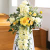 Yellow and white floral spray on a stand