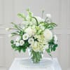 White floral arrangement in a clear glass vase