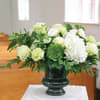 White floral arrangement in a dark vase