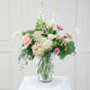 Pastel mixed flower arrangement in a clear glass vase