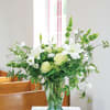 White lilies and pale roses in a glass vase
