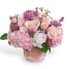 Pink and white bouquet of roses and hydrangeas in a glass vase