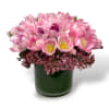 Pink tulips arranged in a dark green glass vase
