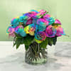 Rainbow roses arranged in a clear glass vase