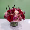 Mixed bouquet of red and pink roses in a glass vase