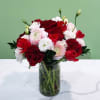 Bouquet of red and white flowers in a clear glass vase