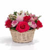 Basket of pink and red roses with white lilies and carnations