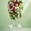 Standing floral spray with roses and chrysanthemums on an easel