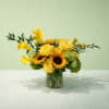 Yellow flowers arranged in a clear glass vase