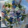 Large pastel bouquet with butterflies and mixed blooms wrapped in pale blue paper