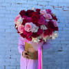 Large bouquet of red, pink, and white roses in a gold box