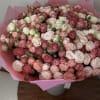 Large bouquet of pink and white roses wrapped in pink paper