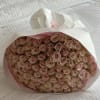 Large bouquet of pale pink roses wrapped in white paper