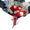 Bouquet of red and white roses wrapped in black-and-white paper with a red ribbon