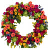 Colorful floral wreath with roses and gerbera daisies