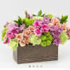 Mixed pink and green floral arrangement in a rectangular wooden box