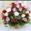 Basket arrangement of red, pink, and white roses