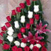Large arrangement of red and white roses with pink lilies
