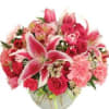 Pink lilies and roses arranged in a round vase