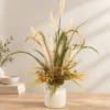 Dried grass arrangement in a white ceramic vase