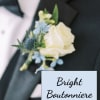 White rose and blue flower boutonniere on a black tuxedo lapel