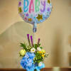 New baby balloon with colorful floral arrangement in green vase with blue and yellow flowers