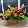 Colorful mixed flower arrangement in a wicker basket