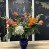Colorful mixed bouquet in a blue glass vase