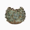 Textured ceramic vase with a blue-green and brown speckled surface