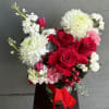Bouquet of red roses, white chrysanthemums, and pink carnations with a red ribbon