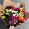 Mixed bouquet of colorful roses and alstroemeria wrapped in brown paper
