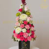 Tall pink and white floral arrangement in a black cylinder box