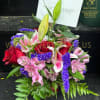 Bouquet of red roses, pink lilies, and purple filler flowers