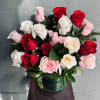 Bouquet of red, white, and pink roses in a green vase