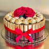 Chocolate gift box topped with two red roses and a ribbon